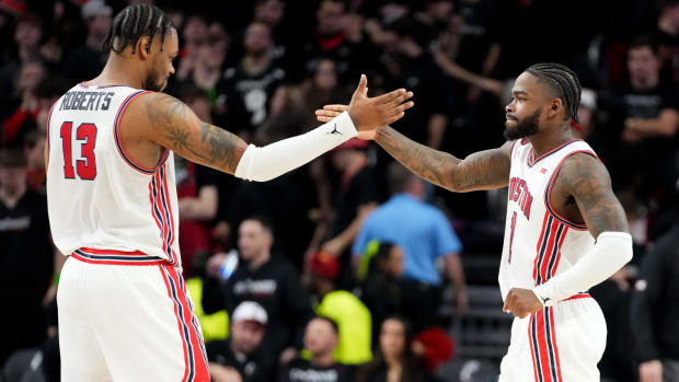 Houston Cougars forward J'Wan Roberts (13) and Houston Cougars guard Jamal Shead (1) celebrate the win at the conclusion of the second half of an NCAA college basketball game against the Cincinnati Bearcats, Saturday, Feb. 10, 2024, at Fifth Third Arena in Cincinnati.